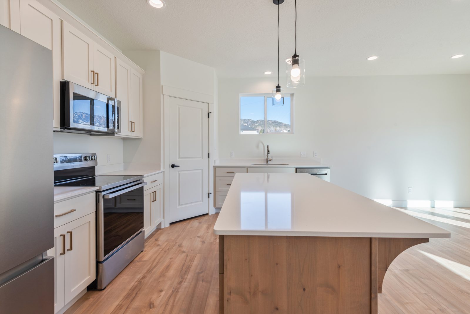 Kitchen with stainless appliances and island seating